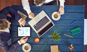 People sitting by the table, talking about marketing touchpoints