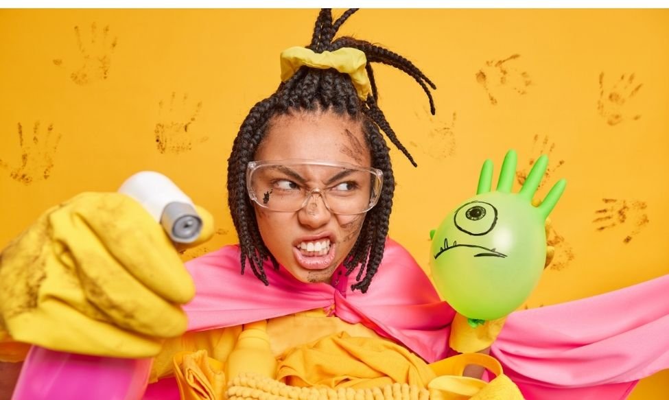 Woman in cleaning gear holding a balloon with a drawn face, making a dramatic pose – funny meme marketing image.