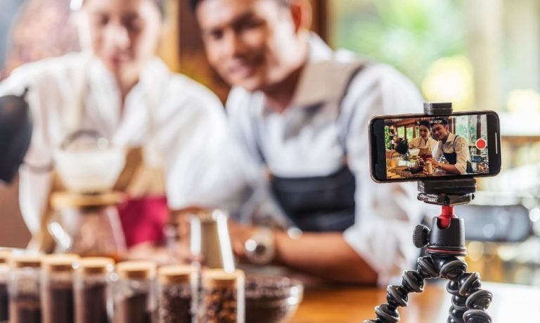 Content creators filming coffee tutorial as part of social-first strategies and marketing campaign.