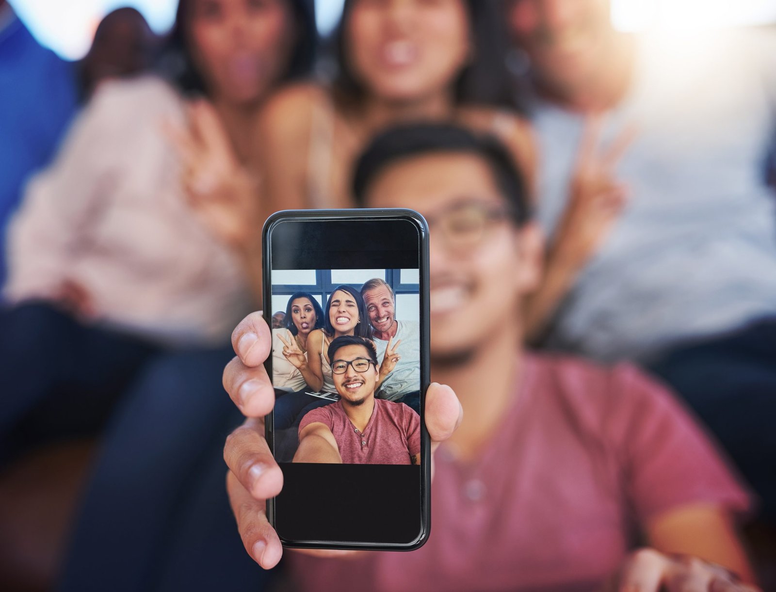 Friends taking selfie to show audience engagement in social-first strategies and marketing.